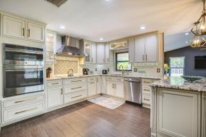 a kitchen with white cabinets and stainless steel appliances at Coral Springs Home with Proximity to Golf and Beaches! in Coral Springs