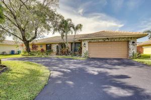 a house with a driveway in front of it at Coral Springs Home with Proximity to Golf and Beaches! in Coral Springs