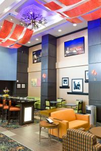 a lobby of a hotel with chairs and tables at Hampton Inn and Suites Tulsa Central in Tulsa