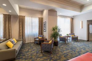 a lobby of a hotel with a couch and chairs at Hampton Inn & Suites Tulsa Downtown, Ok in Tulsa