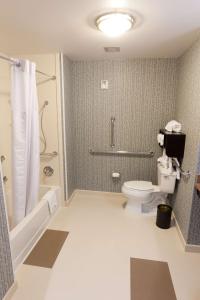 a bathroom with a toilet and a shower at Hampton Inn and Suites Tulsa Central in Tulsa