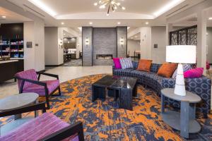 a living room with a couch and chairs and a table at Homewood Suites By Hilton Tulsa Catoosa in Catoosa