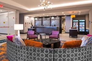 a lobby with a couch and chairs and a table at Homewood Suites By Hilton Tulsa Catoosa in Catoosa