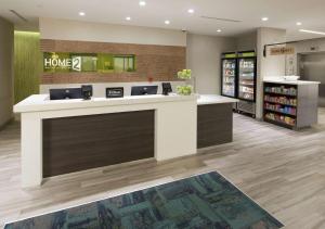 a lobby of a home store with a counter at Home2 Suites by Hilton Owasso in Owasso