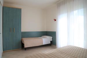 Кровать или кровати в номере Villaggio Mare Blu