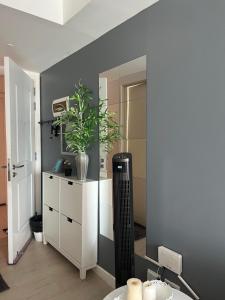 a room with a white dresser and a mirror at The Bahamas & Maldives Suites at Azure Residences near Manila Airport in Manila