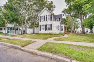 a white house with a fence and a sidewalk at Cozy Glens Falls Getaway Less Than 1 Mi to Downtown in Glens Falls