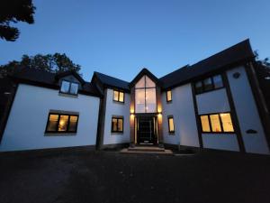 a white house with its lights on at night at Stunning Detached House in Bassett in Southampton