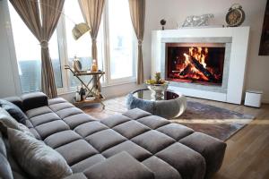 a living room with a couch and a fireplace at RoyalDeluxe Penthouse by Kevany in Cologne