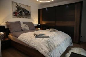 a bedroom with a large bed with a large window at RoyalDeluxe Penthouse by Kevany in Cologne