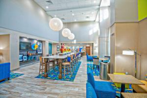 a cafeteria with blue chairs and a dining room at Hampton Inn & Suites Mary Esther-Fort Walton Beach, Fl in Mary Esther