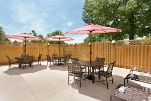 a patio with tables and chairs with umbrellas at Hampton Inn Washington-Dulles International Airport South in Chantilly