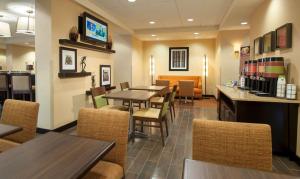 a dining room with tables and chairs in a restaurant at Hampton Inn Washington-Dulles International Airport South in Chantilly