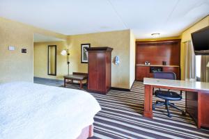 a hotel room with a bed and a desk at Hampton Inn Washington-Dulles International Airport South in Chantilly