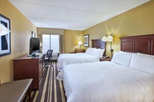 a hotel room with two beds and a flat screen tv at Hampton Inn Washington-Dulles International Airport South in Chantilly