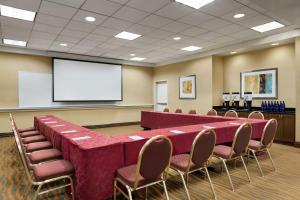 a conference room with a table and chairs and a screen at Hampton Inn Washington-Dulles International Airport South in Chantilly