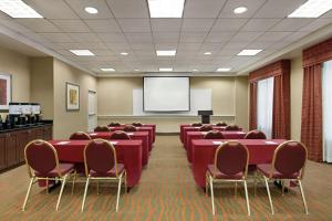 a conference room with red tables and chairs and a screen at Hampton Inn Washington-Dulles International Airport South in Chantilly