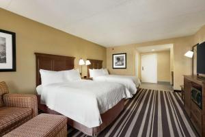 a hotel room with two beds and a television at Hampton Inn Washington-Dulles International Airport South in Chantilly