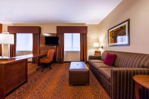 a hotel room with a couch and a desk at Hampton Inn & Suites Boulder North in Boulder