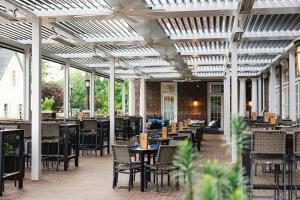 a patio with tables and chairs in a restaurant at The Mayton in Cary
