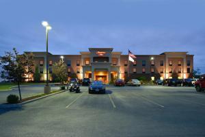 a parking lot in front of a hotel at Hampton Inn Utica in Utica