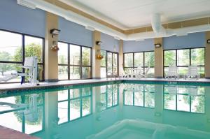 a swimming pool in a hotel with glass windows at Hampton Inn Wooster in Wooster