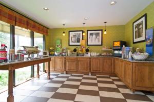 a kitchen with wooden cabinets and a checkered floor at Hampton Inn Wooster in Wooster