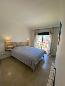 sypialnia z łóżkiem i dużym oknem w obiekcie Roda Golf Sunparadise w mieście San Javier