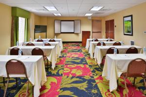 a conference room with tables and chairs and a screen at Hampton Inn Waynesboro/Stuarts Draft in Fishersville