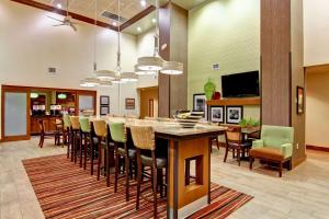 a large kitchen and dining room with a large table and chairs at Hampton Inn & Suites Leesburg in Leesburg