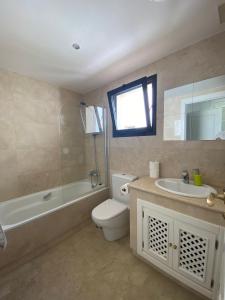 a bathroom with a toilet and a sink and a bath tub at Roda Golf Sunparadise in San Javier