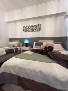 a bedroom with two beds with a teddy bear laying on them at The Roomah in Bentong