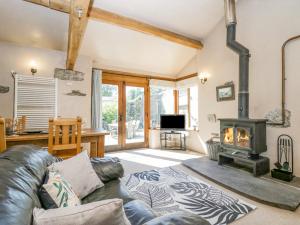 a living room with a couch and a wood stove at Egg Pudding Stone in Grange Over Sands