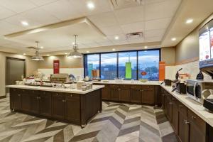 a large kitchen with a large window at Hampton Inn St. Catharines Niagara in St. Catharines