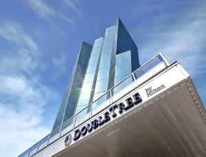 a building with a sign on top of it at DoubleTree by Hilton Edmonton Downtown in Edmonton