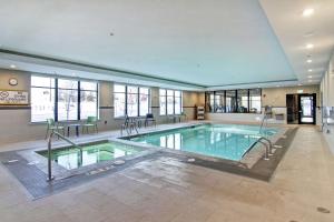 a large swimming pool in a building at Home2 Suites By Hilton Edmonton South in Edmonton