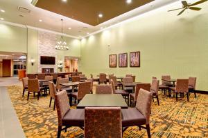 a restaurant with tables and chairs in a room at Homewood Suites by Hilton Waterloo/St. Jacobs in Waterloo