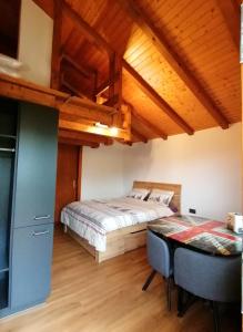 a bedroom with a bed and a desk in a room at Les Comblés des Combes in Ollon