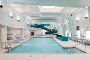 a swimming pool with a slide in a room at Hampton Inn & Suites by Hilton Dartmouth - Halifax in Halifax