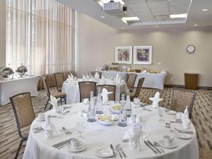 a dining room with white tables and chairs at Hampton Inn by Hilton Halifax Downtown in Halifax