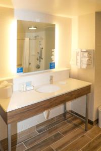 a bathroom with a sink and a large mirror at Hampton Inn Ellensburg in Ellensburg