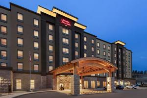 a hotel building with a gazebo in front of it at Hampton Inn & Suites Kelowna, British Columbia, Canada in Kelowna