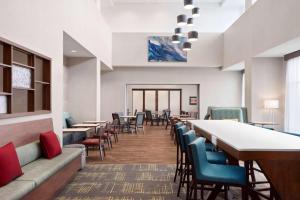 a waiting room with tables and chairs at Hampton Inn & Suites Kelowna, British Columbia, Canada in Kelowna