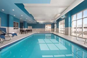 a swimming pool in a hotel with blue walls at Hampton Inn & Suites Kelowna, British Columbia, Canada in Kelowna