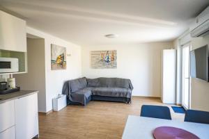 a living room with a couch and a table at Apartman Stela u Kamporu in Kampor