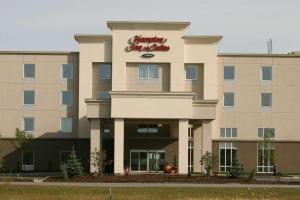 a building with a sign on the front of it at Hampton Inn & Suites Red Deer in Red Deer