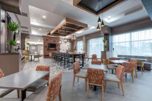 a restaurant with tables and chairs in a room at Hampton Inn & Suites Charlottetown in Charlottetown