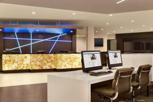 a conference room with two computer monitors on a desk at DoubleTree by Hilton Hotel Toronto Airport West in Mississauga