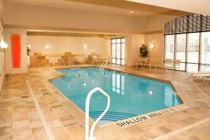 a large indoor pool in a hotel room with a swimming pool at Hampton Inn by Hilton Brampton - Toronto in Brampton