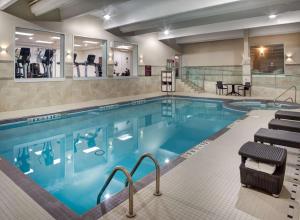 a swimming pool with blue water in a hotel at Doubletree by Hilton Toronto Airport, ON in Toronto